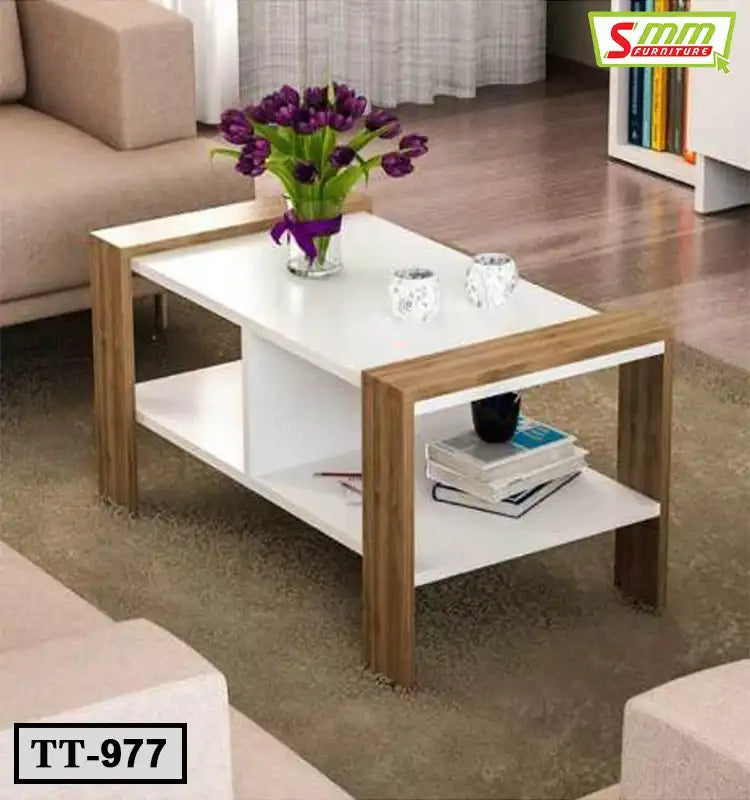 Modern white tea table with wooden legs, glass vase with purple flowers, books and candles Main image