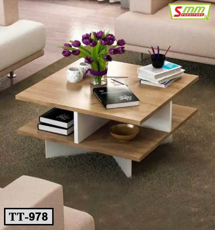Modern wooden tea table with books, flowers, and decor in a stylish living room setting
