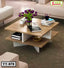Modern wooden tea table with books, flowers, and decor in a stylish living room setting