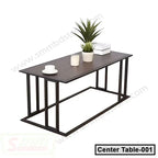 Modern rectangular tea table with black metal frame, dark wood top, and minimalist decor.
