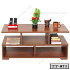 Modern wooden tea table with shelves, holding mugs, books, plant, remote holder, and magazines