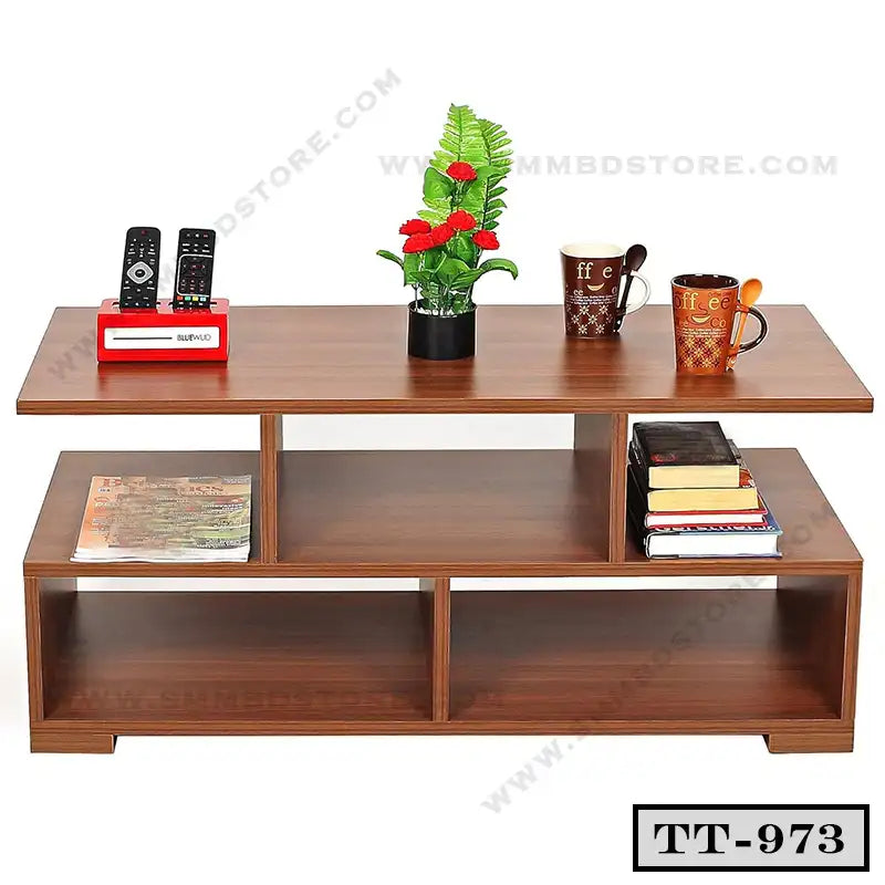 Modern wooden tea table with shelves, holding mugs, books, plant, remote holder, and magazines