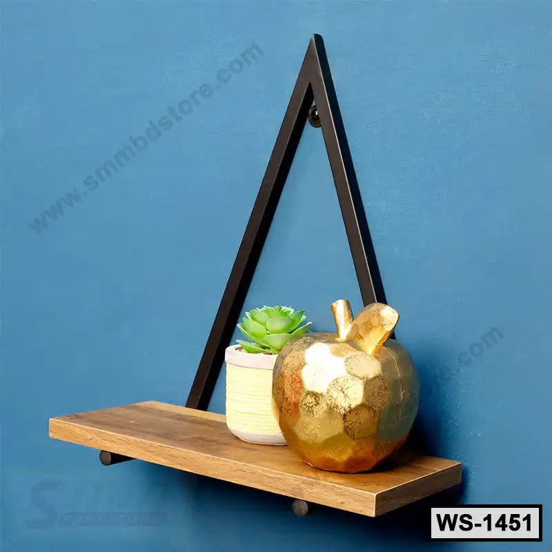 Modern wall shelf with triangular black metal frame, wood plank, gold apple decor, small succulent plant, blue background