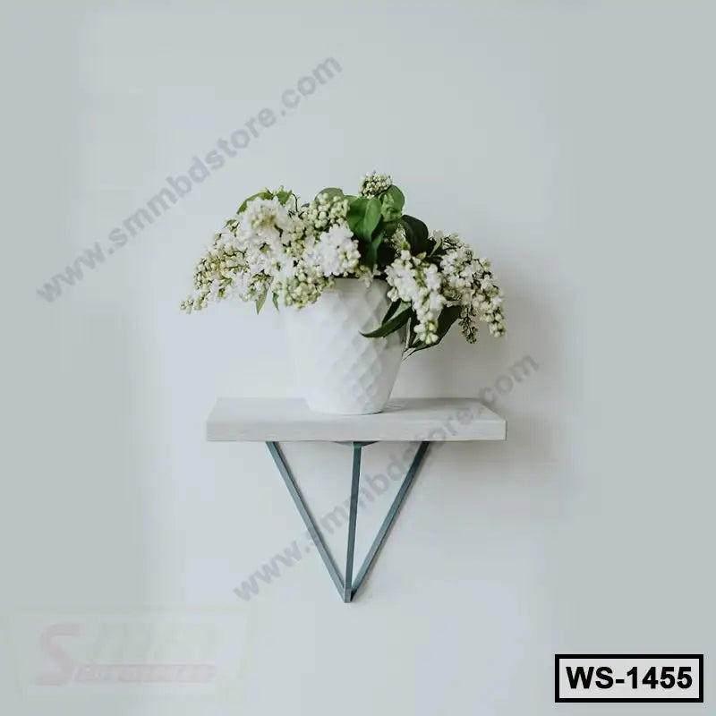 Modern wall shelf with metal brackets holding a white vase of flowers on a light wall