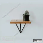 Modern wooden wall shelf with black metal brackets and potted cactus on white wall