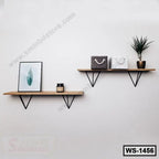 Modern wooden wall shelves with black metal brackets, home decor with plant and framed art