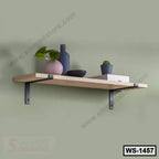 Modern wooden wall shelf with metal brackets, decor items, and small potted plant