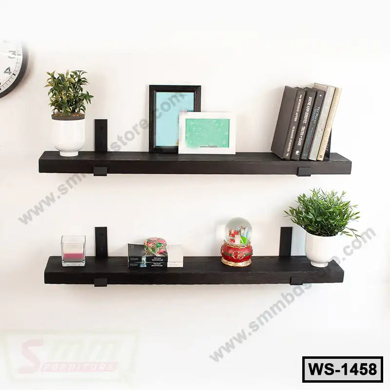 Modern black wall shelves with decor, books, plants and picture frames on white wall