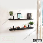 Modern black wall shelves with books, plants, and decor in a bright living room