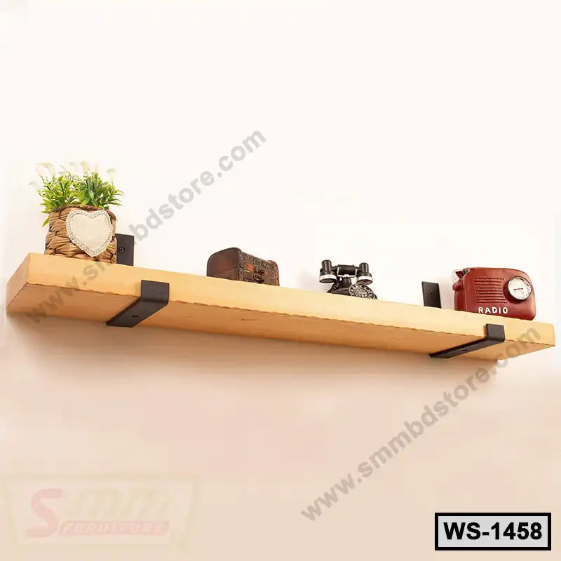 Wooden wall shelf with black brackets, decorated with a plant, vintage camera, and radio