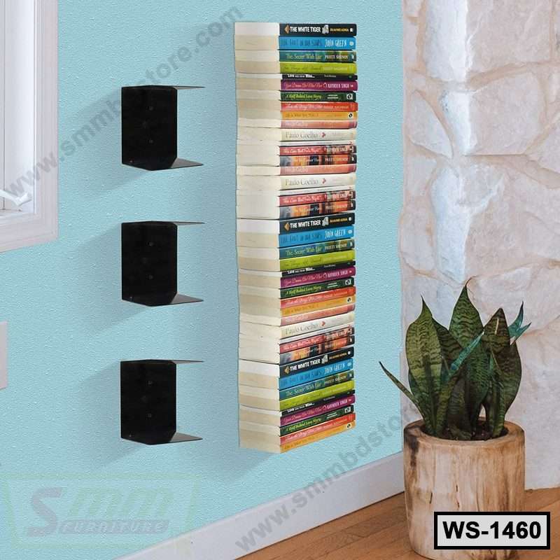 Modern floating wall shelf with stacked books, black brackets, and a potted plant in a bright room