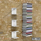Modern wall-mounted white shelves with stacked books on a stone wall background