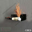 Modern black wall shelf with a book and decorative vase on a gray textured wall