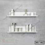 Modern white wall shelves with decorative items mounted on a textured gray wall