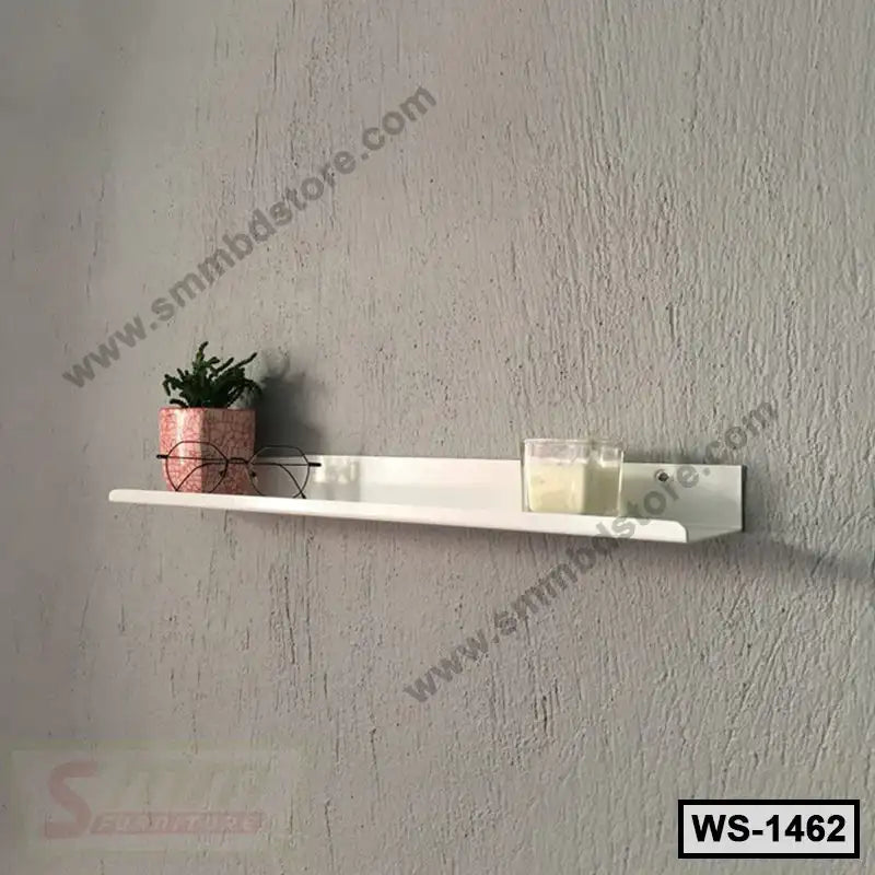 Modern white wall shelf with potted plant, candles, and eyeglasses against a gray wall Main image
