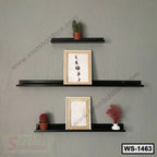 Modern black wall shelf set with picture frames, small potted plants, and decorative items