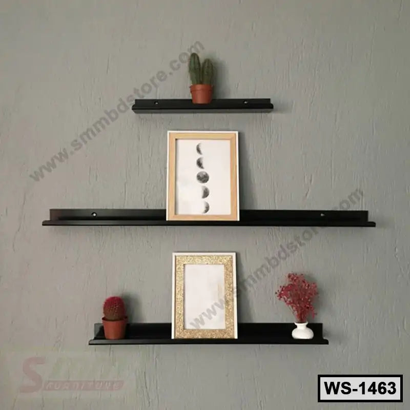 Modern black wall shelf set with picture frames, small potted plants, and decorative items