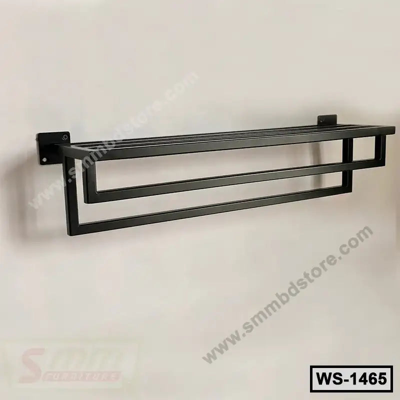 Modern black metal wall shelf with geometric design mounted on a light-colored wall