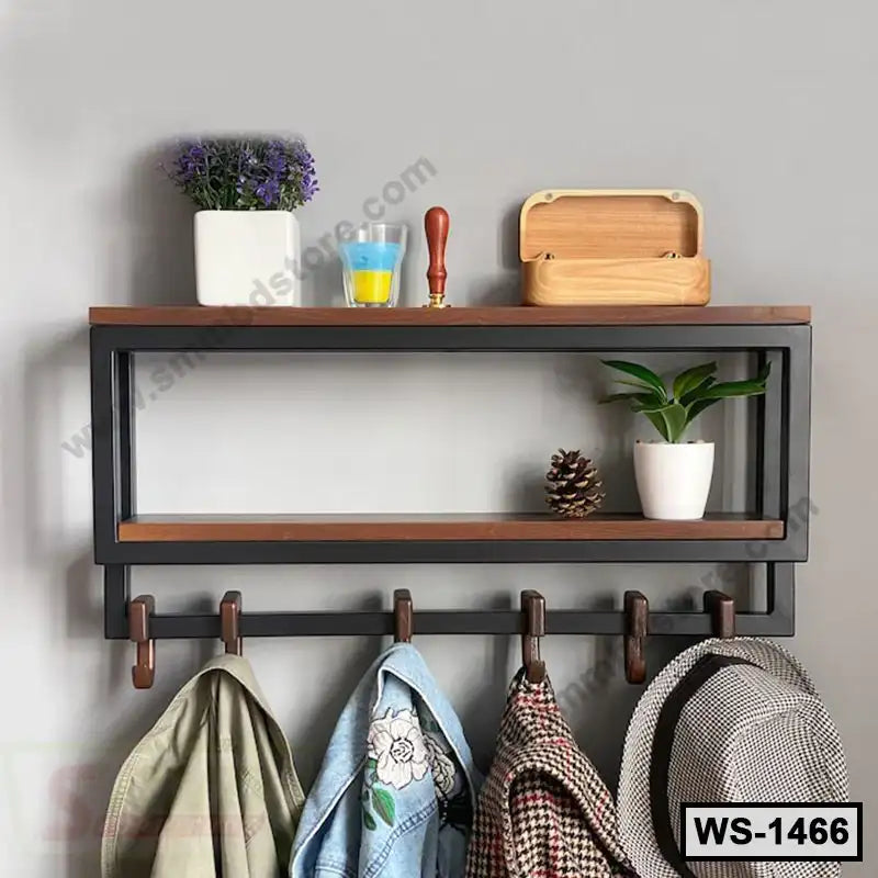 Modern wall shelf with hooks, holding jackets, hats, plants, and decor, perfect for home entryway