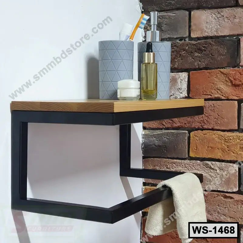 Modern wall-mounted shelf with black metal frame, holding toiletries, against a brick wall.