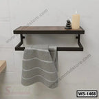 Modern wall-mounted shelf with towel bar, gray towel, candle, and decorative stones