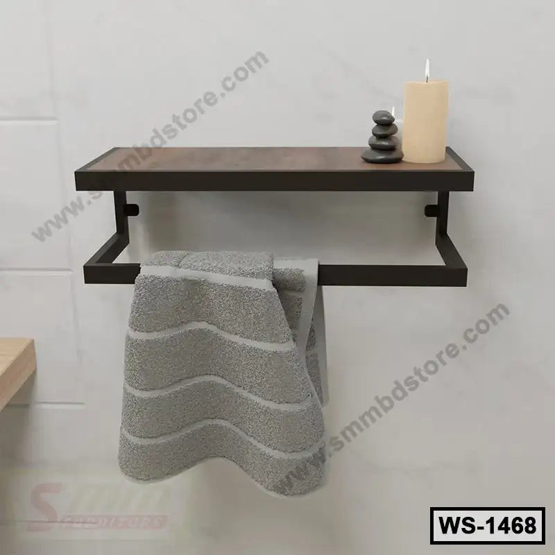 Modern wall-mounted shelf with towel bar, gray towel, candle, and decorative stones