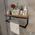 Modern wall shelf with wood top, black metal frame, toiletries, decor, and towel rack