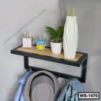 Modern wall shelf with black frame, holding decor, plant and vase, with hooks for hanging items