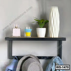 Modern black wall shelf with decorative items, plant, vase, and hooks for hanging essentials