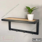 Modern wall-mounted shelf with black frame, wooden top, hooks, and a potted plant decor.