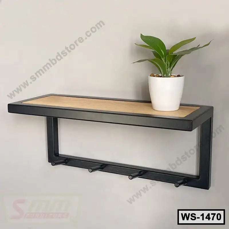 Modern wall-mounted shelf with black frame, wooden top, hooks, and a potted plant decor.