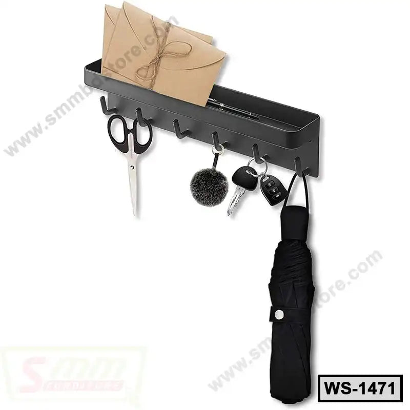 Wall-mounted black metal shelf with hooks, holding scissors, keys, umbrella, and mail organizer.