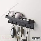 Wall-mounted black metal shelf with hooks holding keys, sunglasses, and small items.