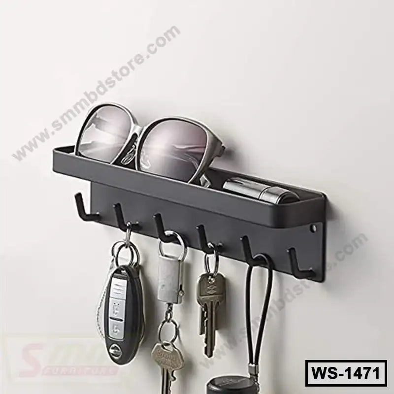 Wall-mounted black metal shelf with hooks holding keys, sunglasses, and small items.