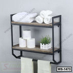 Modern wall-mounted bathroom shelf with towels, toilet paper, and small potted plant