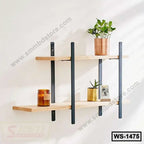 Modern wooden wall shelf with black metal brackets, decorated with plants and candle, ideal for home or office.