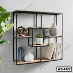 Modern geometric wall shelf with wood and metal, styled with decor, books, and a plant