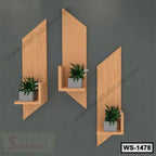 Modern wooden wall shelves set with potted plants on dark gray wall, stylish home decor
