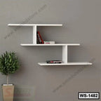 Modern white wall shelf with books, mounted on a gray wall above a decorative plant