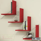 Modern red wall shelves with books, decor piece, and a small plant against a light wall