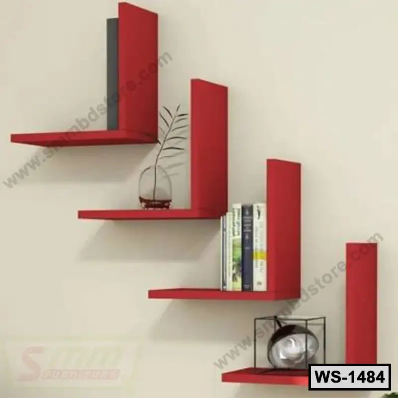 Modern red wall shelves with books, decor piece, and a small plant against a light wall