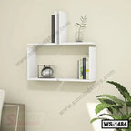 Modern white wall shelf with books, decor items, and a small plant for home or office