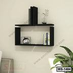 Modern black wall shelf with books, decor items, and a small plant in a living room setting