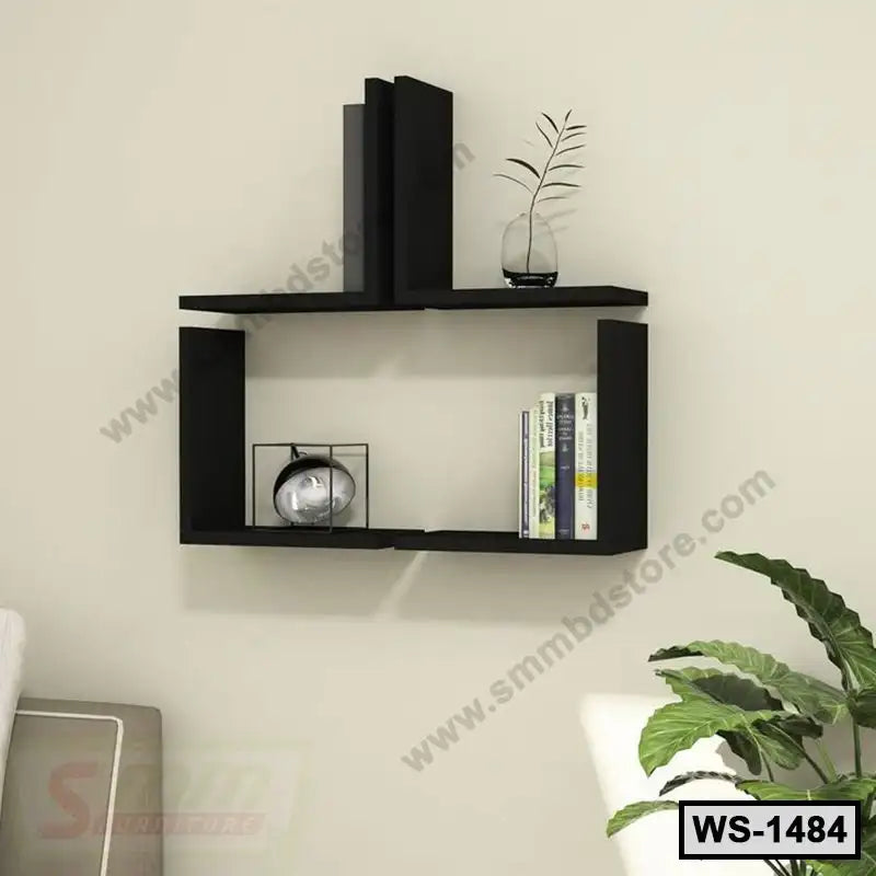Modern black wall shelf with books, decor items, and a small plant in a living room setting