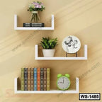Modern white wall shelves with books, clock, potted plant, and decor on beige wall