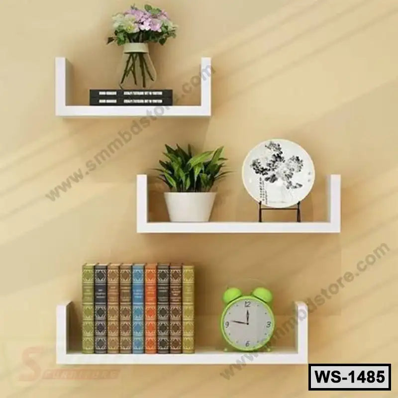 Modern white wall shelves with books, clock, potted plant, and decor on beige wall