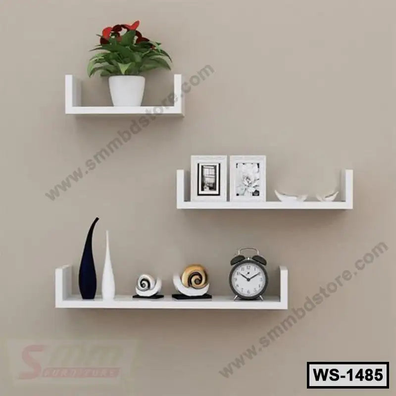 Modern white floating wall shelves with decor, clock, and plant on beige wall