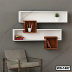 Modern wall shelf with white and brown geometric design, books, decor, and gray armchair