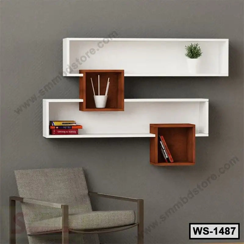 Modern wall shelf with white and brown geometric design, books, decor, and gray armchair