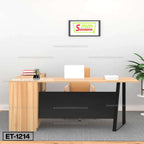 Modern wooden office desk with laptop, chair, plant, and wall art in minimalist workspace.